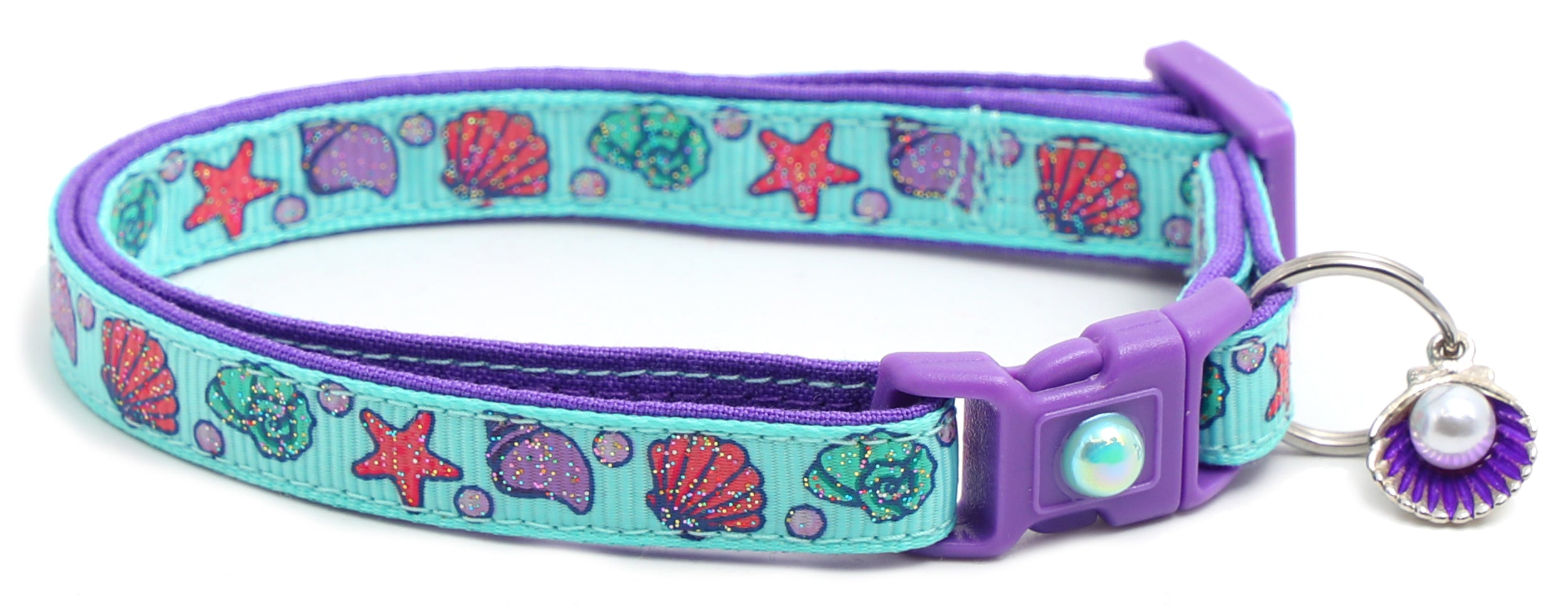 Beachcomber Breakaway Cat Collar in vibrant colors, featuring a breakaway clip and removable bell, made from soft reinforced cotton.
